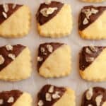 Three lines of ginger shortbread cookies, half dipped in chocolate and crystallized ginger.