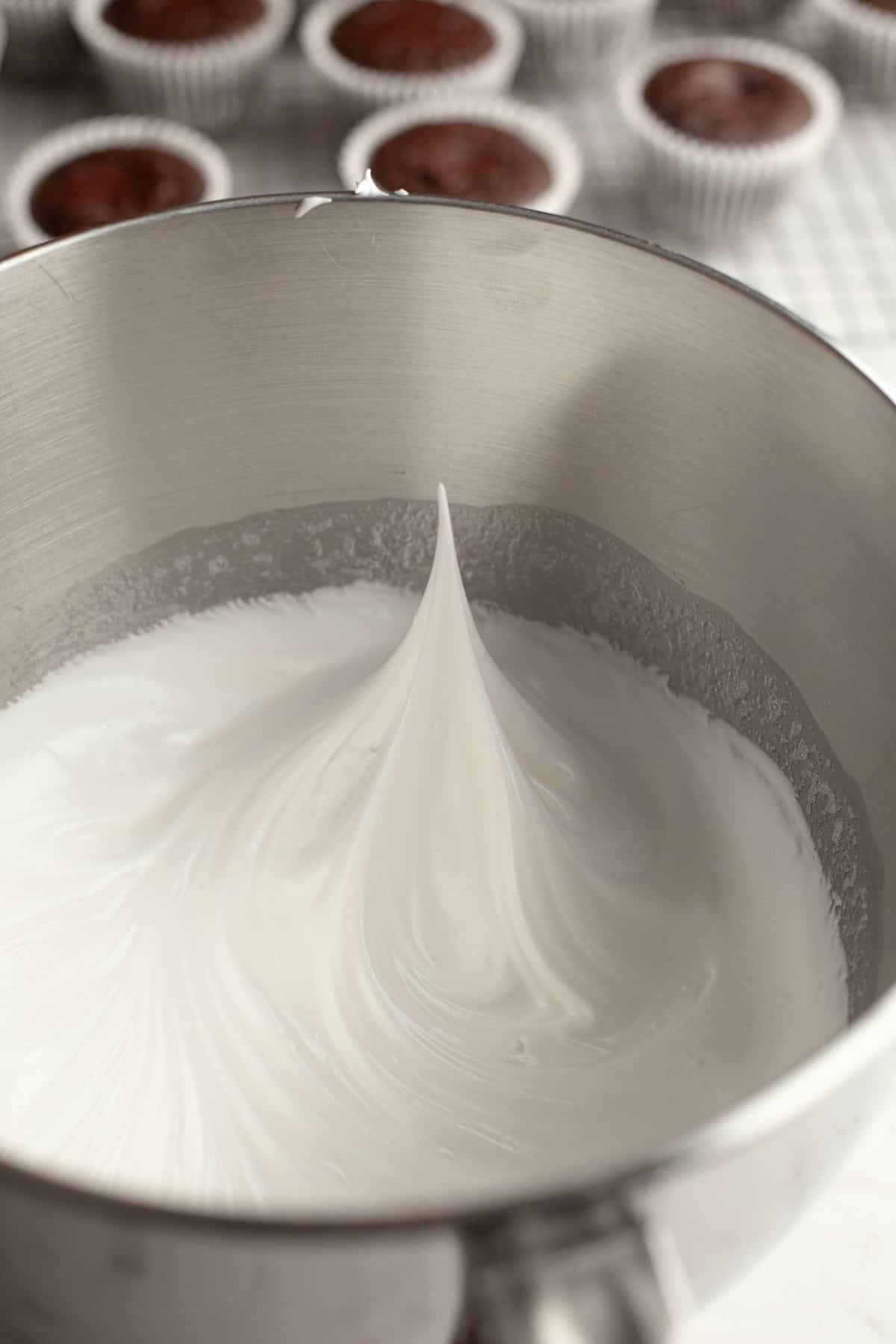 Whipped meringue in a silver bowl.