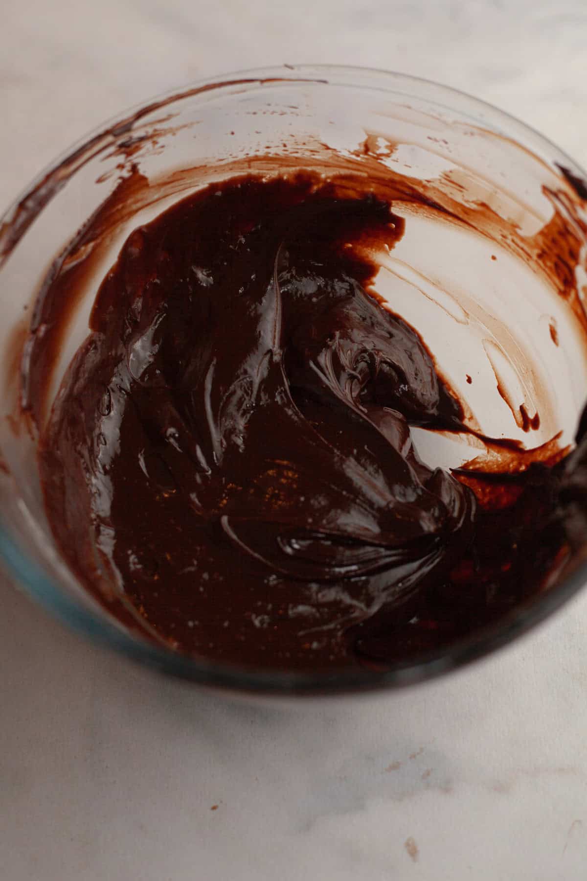 Chocolate ganache in a glass bowl.