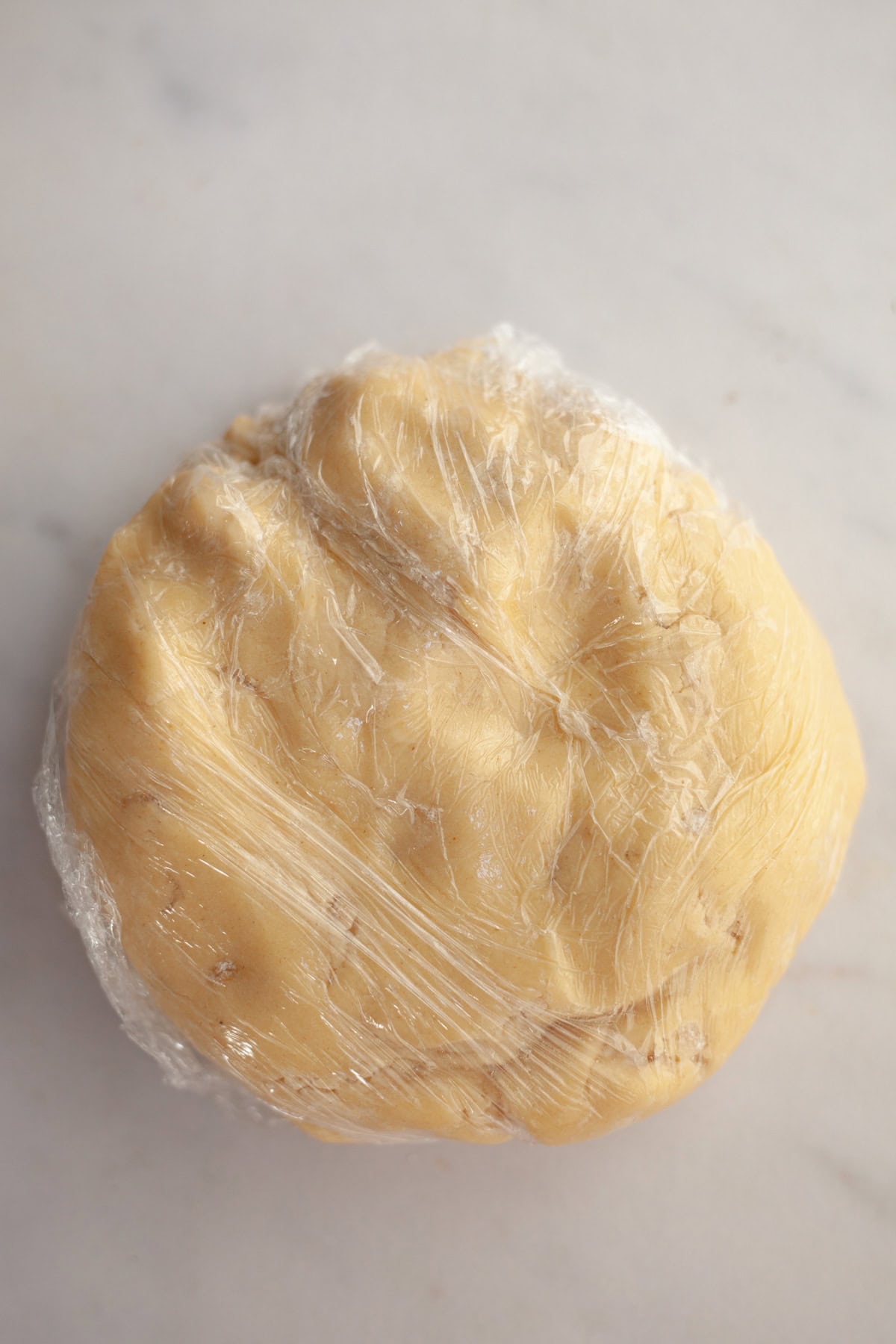 Ginger cookie dough wrapped in plastic.