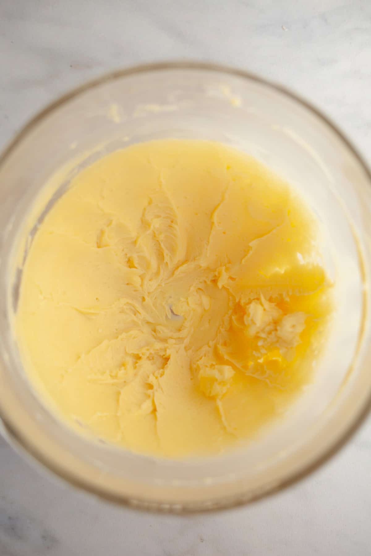 Creamed butter and sugar in a glass bowl.