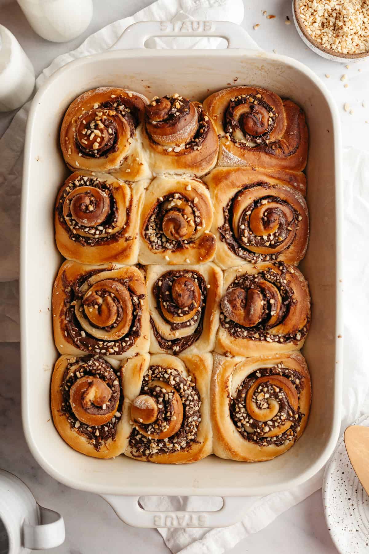 A large rectangular baking dish with baked Nutella cinnamon rolls.