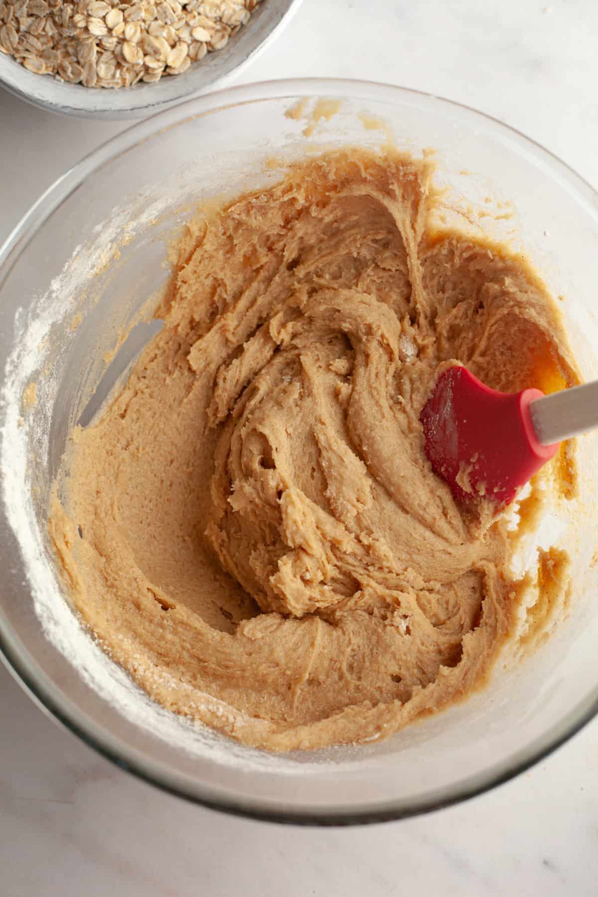 Beige cookie dough in a glass bowl.