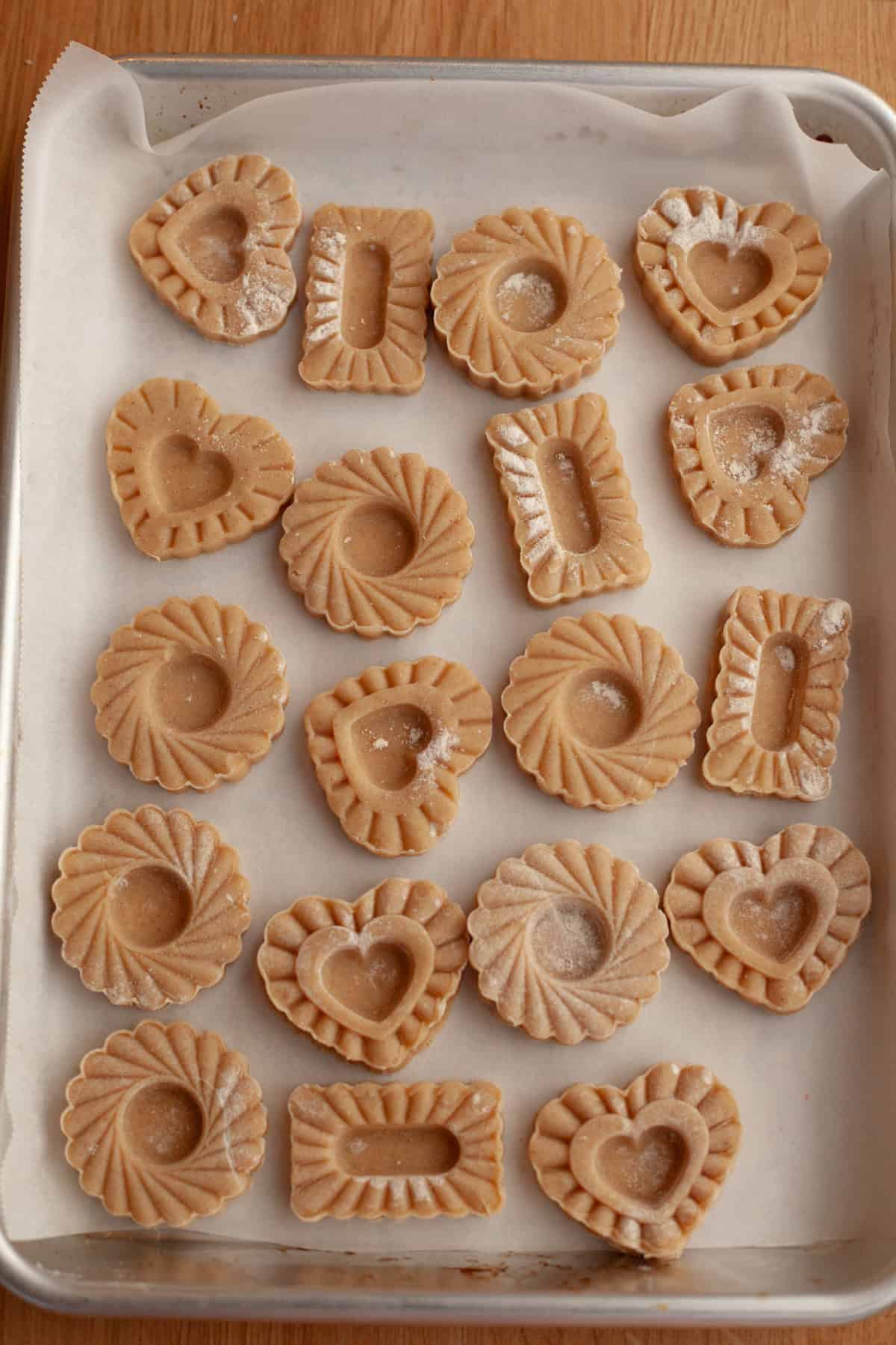 Unbaked cinnamon shortbread cookies on parchment paper.