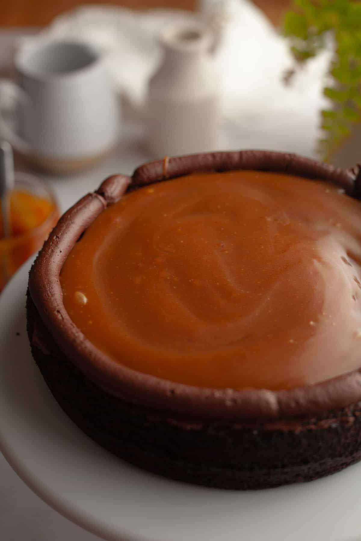 One layer of chocolate cake with chocolate frosting piped around the edge and the middle is filled with caramel sauce.