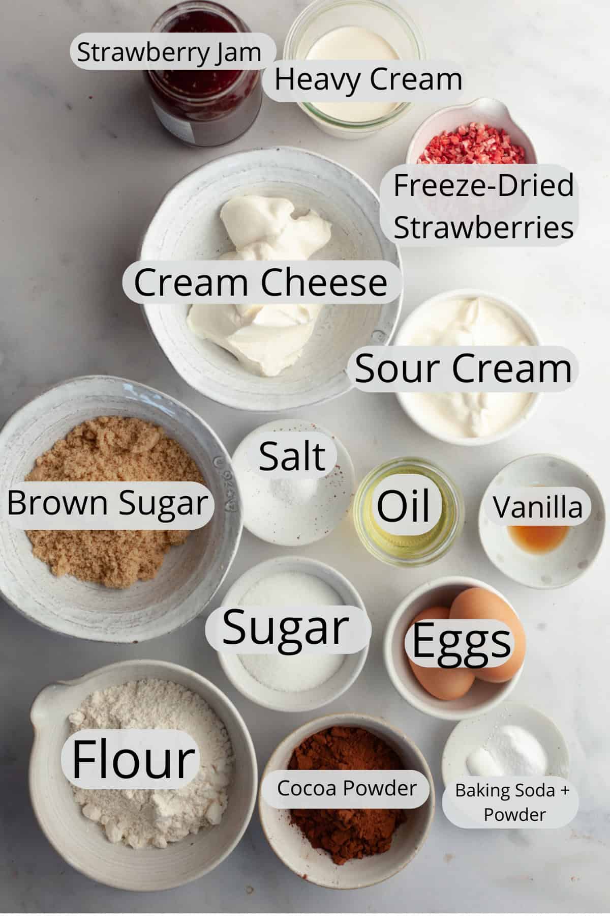 All the ingredients needed to make strawberry chocolate cupcakes, weighed out into small bowls.