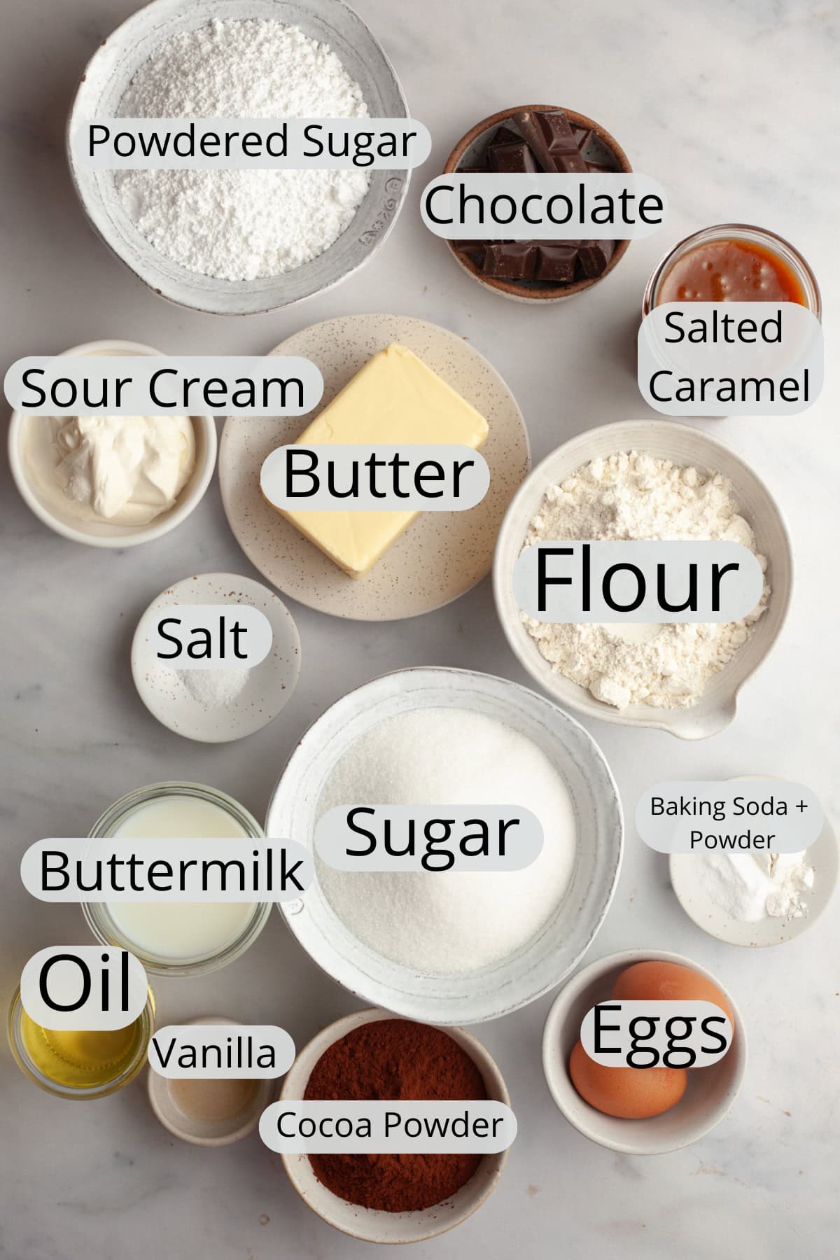 All the ingredients needed to make a salted caramel chocolate cake, weighed out into small bowls.
