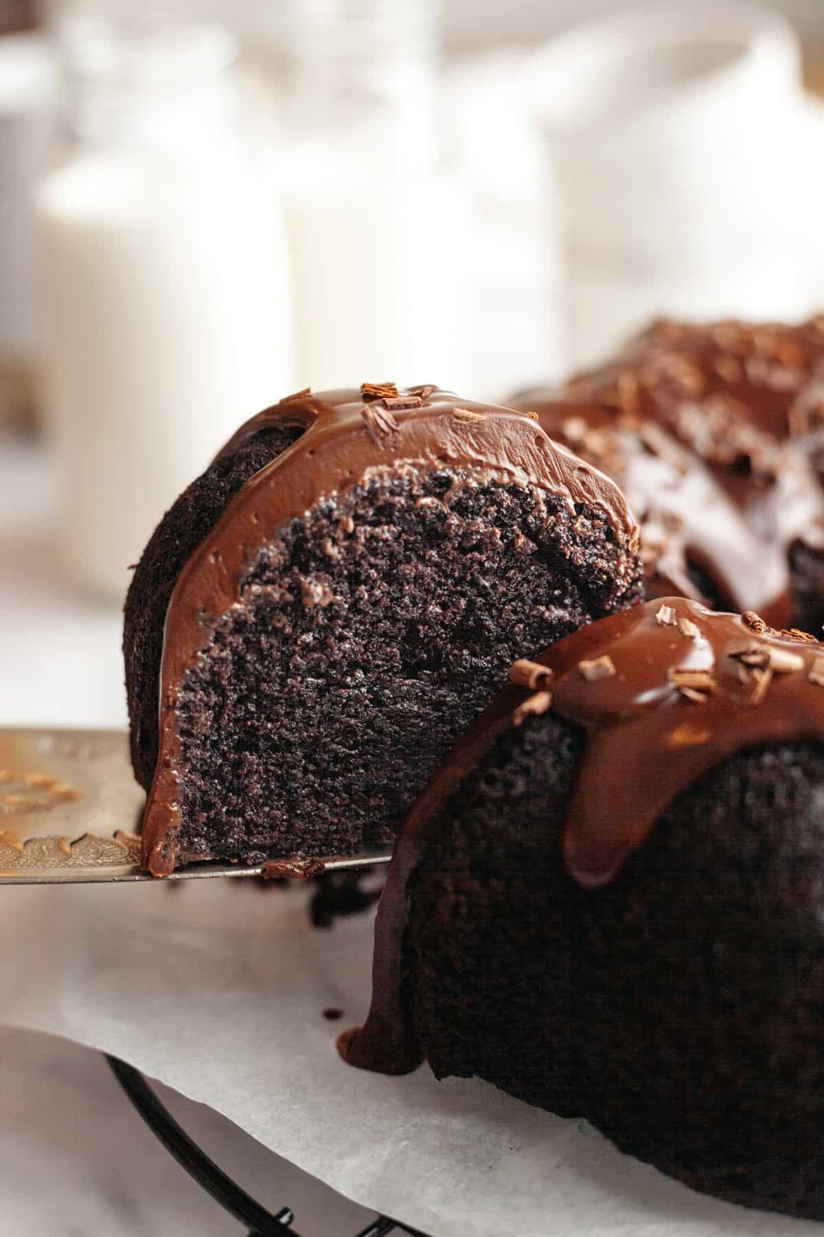 A slice of double chocolate bundt cake being lifted out.