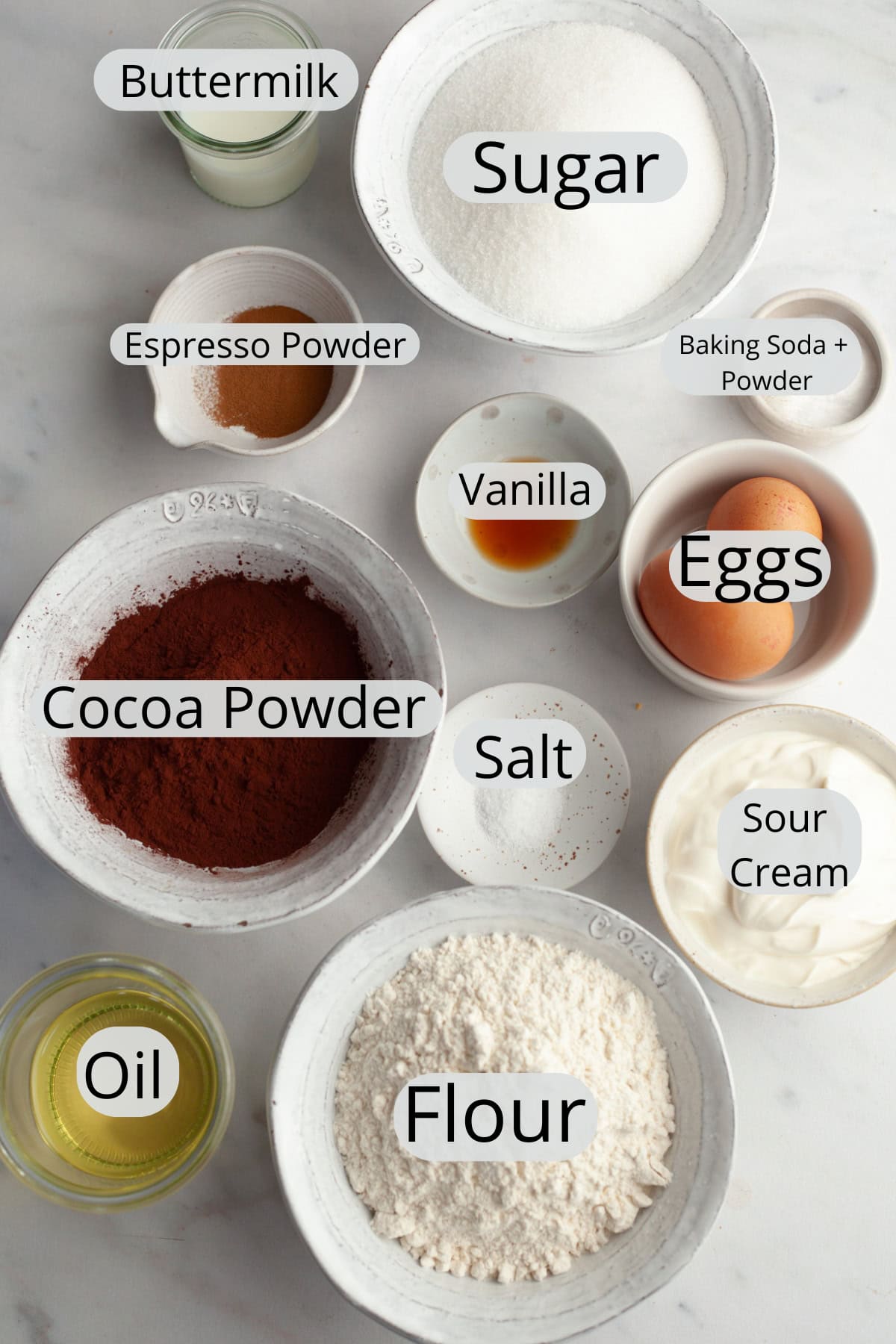 All the ingredients needed to make a chocolate bundt cake, weighed out into small bowls.