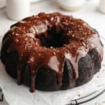 A chocolate bundt cake covered in chocolate ganache.