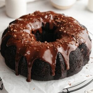 A chocolate bundt cake covered in chocolate ganache.