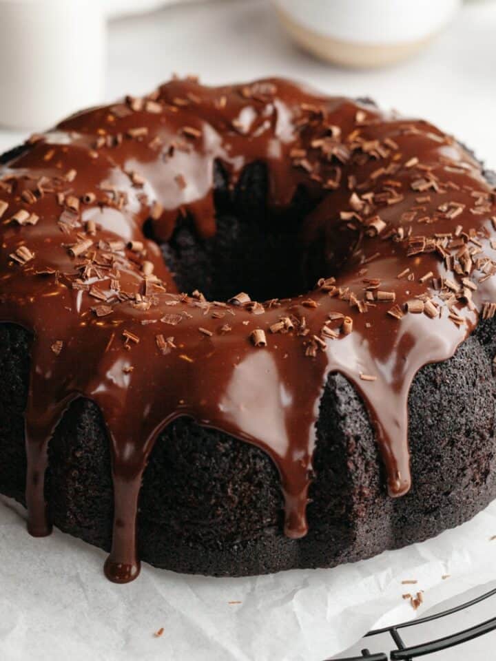 A chocolate bundt cake covered in chocolate ganache.