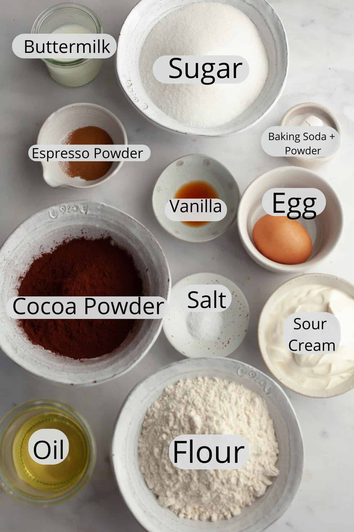 All the ingredients needed to make mini chocolate bundt cakes, weighed out into small bowls.
