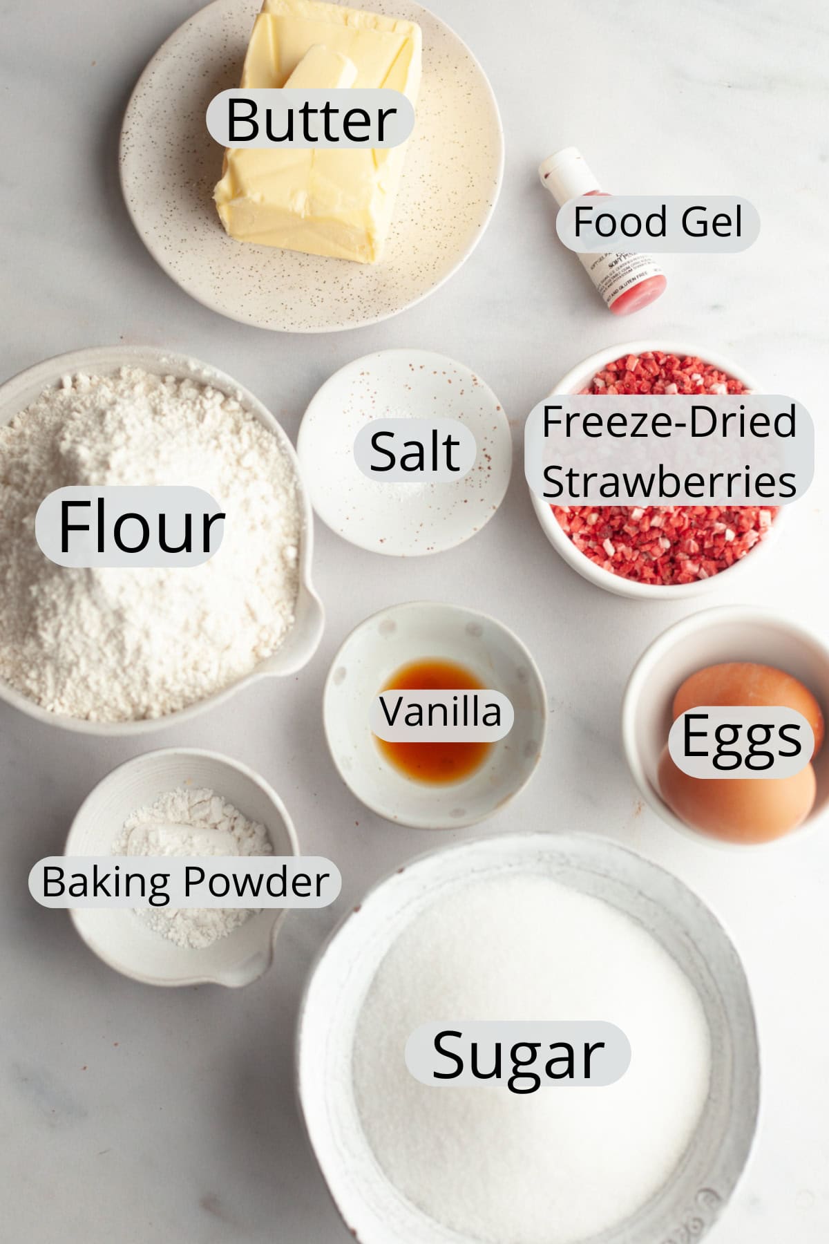 All the ingredients needed to make strawberry sugar cookies, weighed out into small bowls.