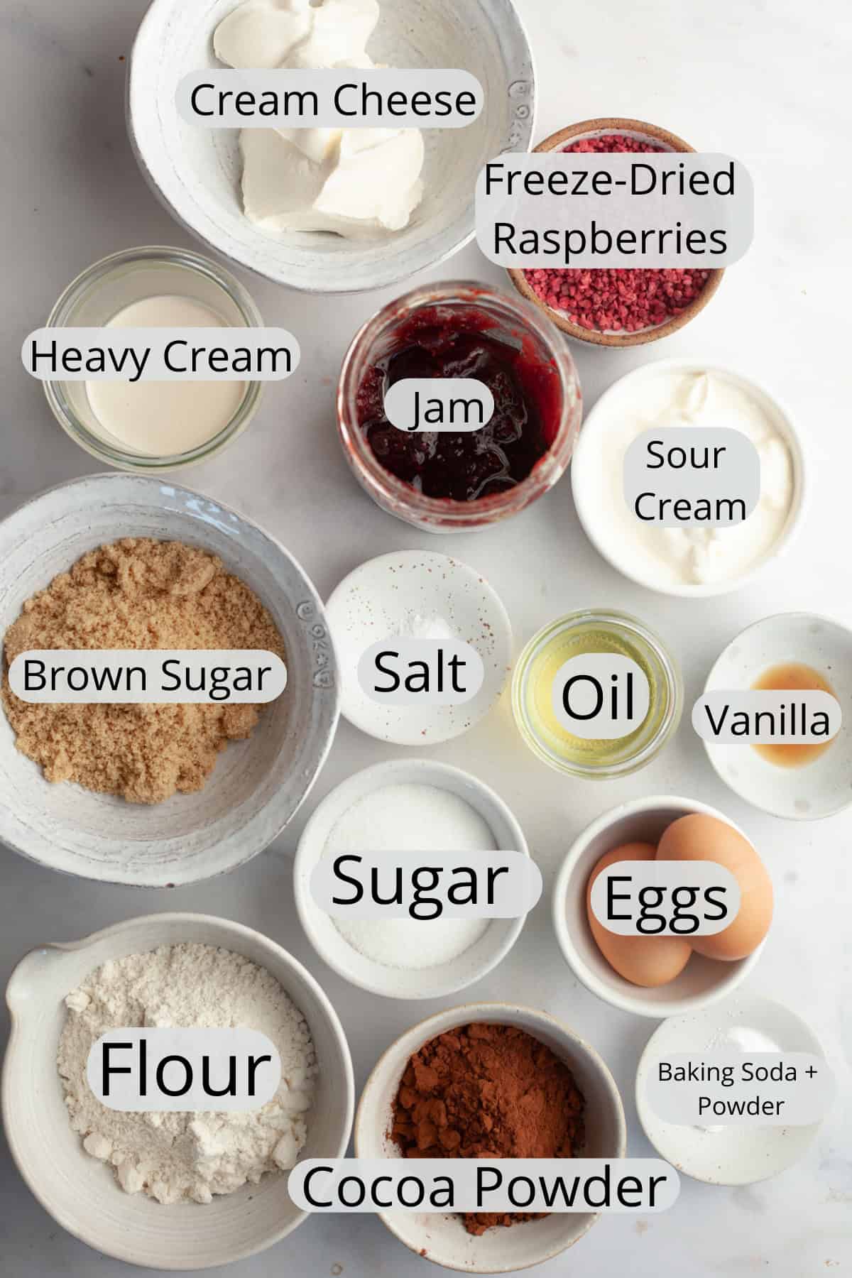 All the ingredients needed to make raspberry filled chocolate cupcakes, weighed out into small bowls.