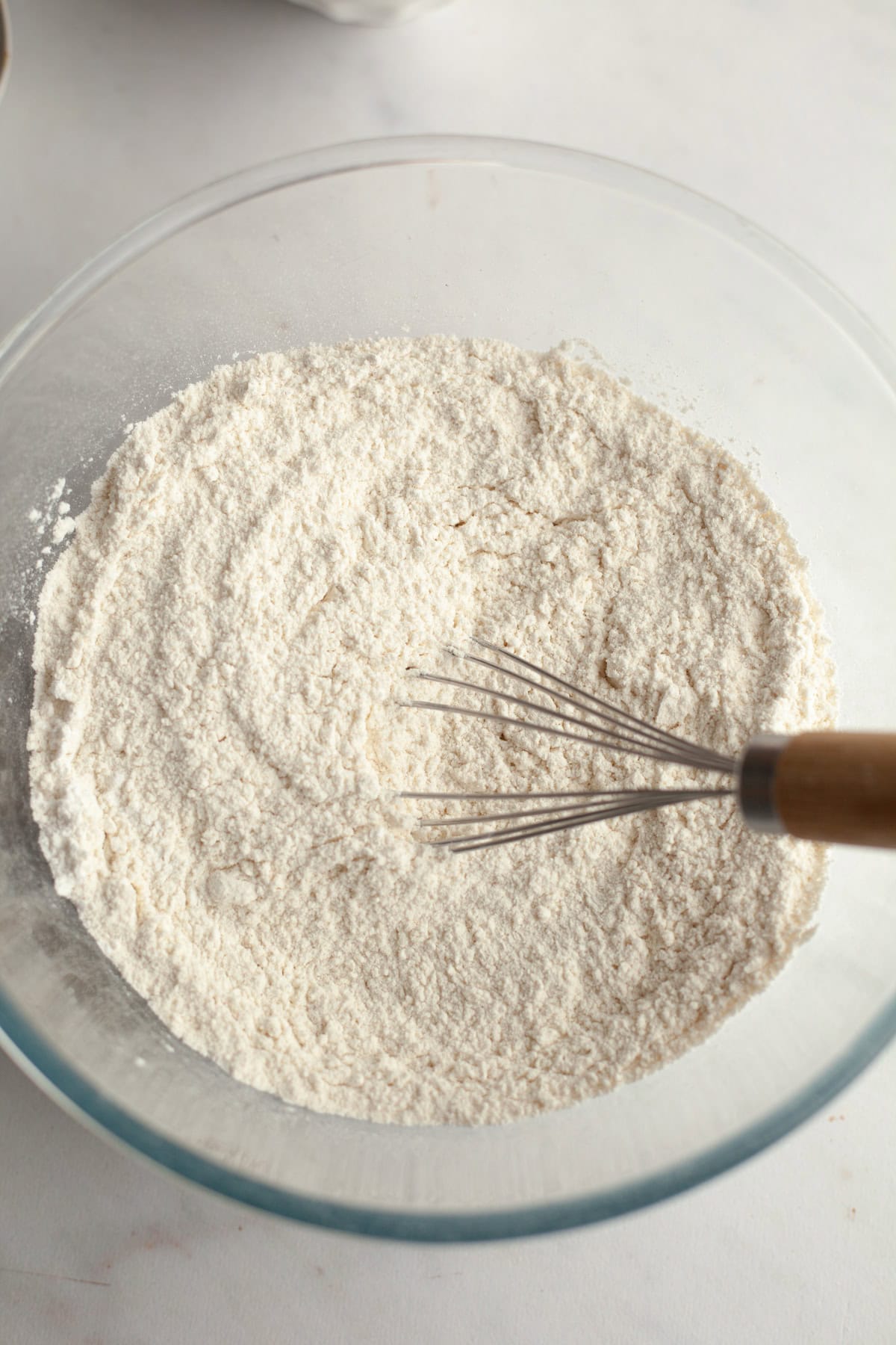 Flour in a glass mixing bowl.