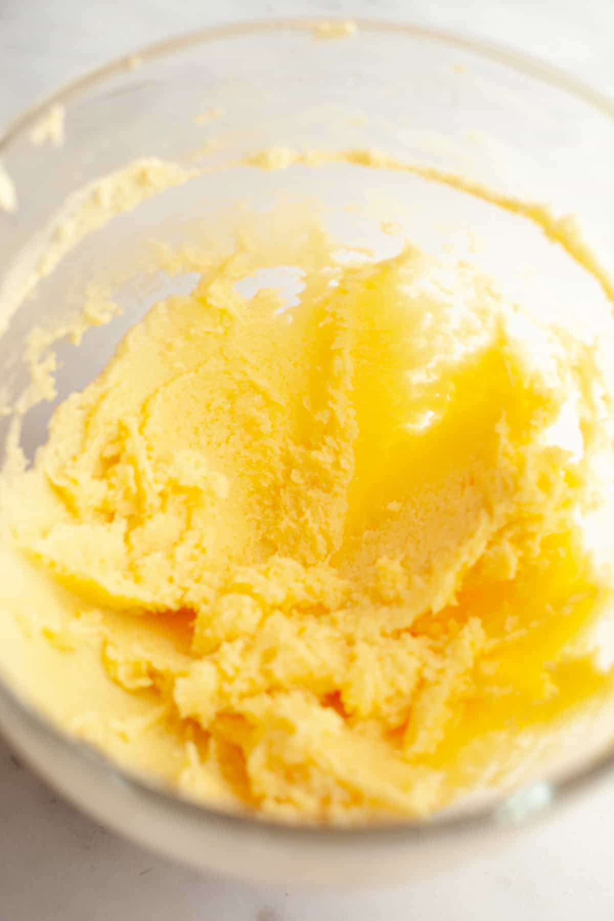 Sugar cookie dough in a glass mixing bowl.