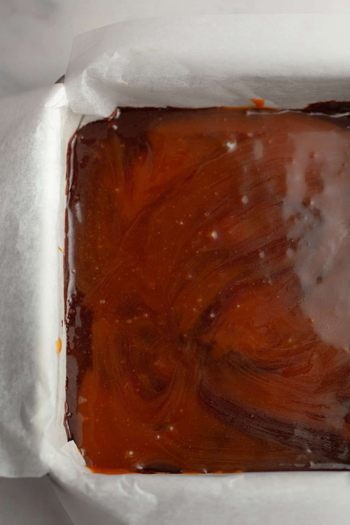 Unbaked salted caramel brownies in a pan.