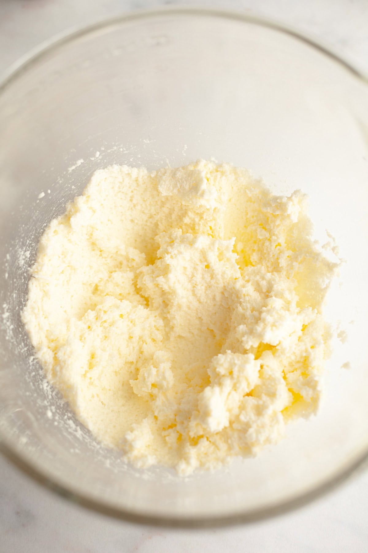 Creamed butter and sugar in a glass mixing bowl.