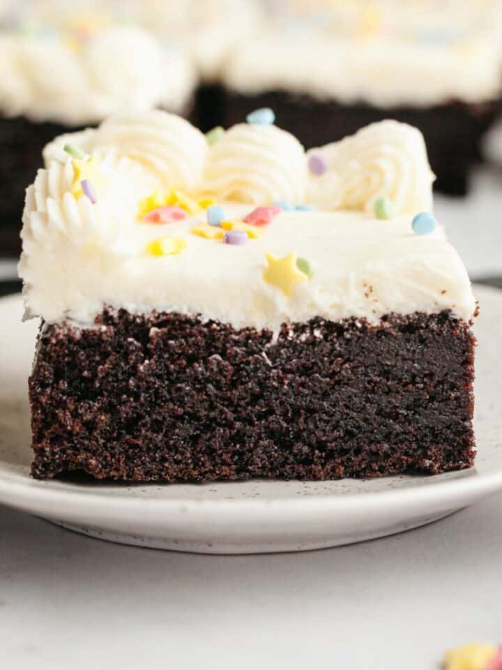 A slice of moist chocolate sheet cake with vanilla buttercream.