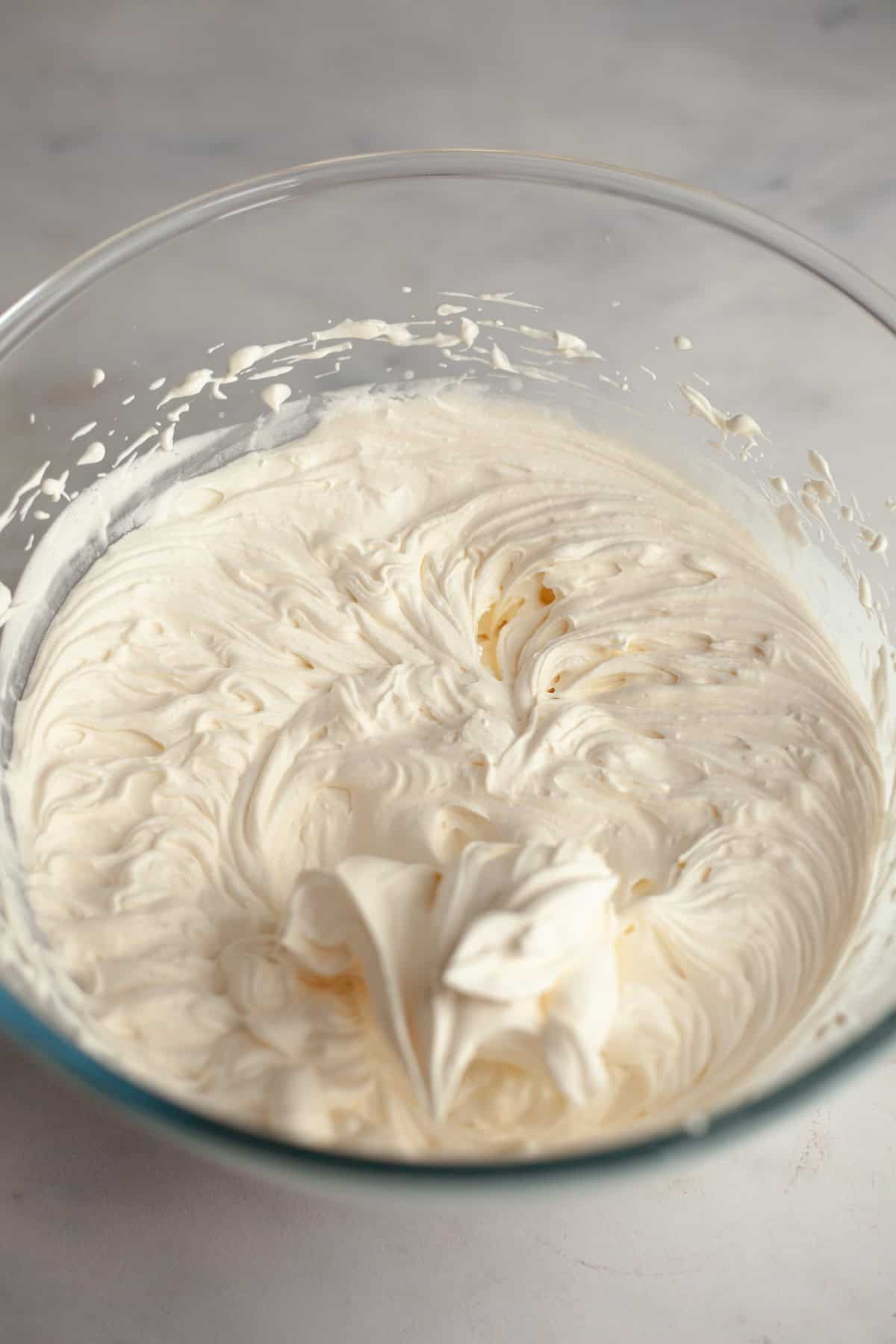 A large glass bowl with whipped cream.