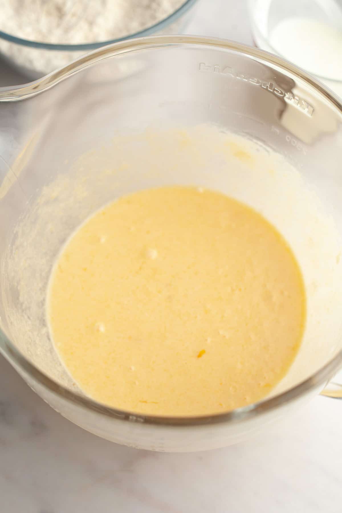 Yellow batter in a glass bowl.