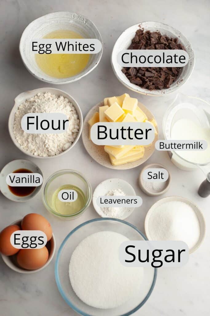 All the ingredients needed to make yellow birthday cake with chocolate Swiss meringue buttercream, weighed out into small bowls.