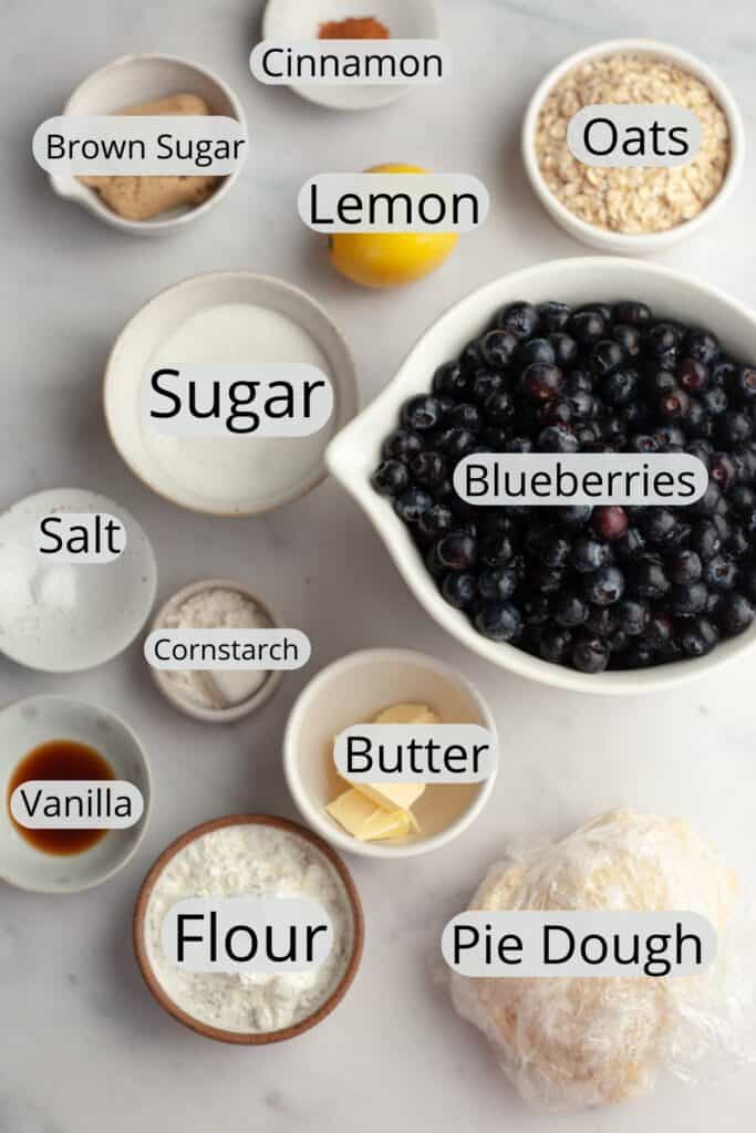 All the ingredients needed to make a blueberry crumble pie, weighed out into small bowls.