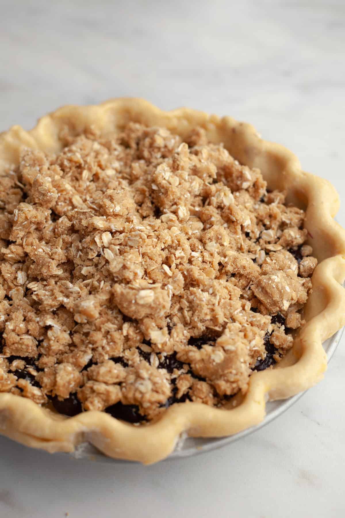 Unbaked blueberry crumb pie.