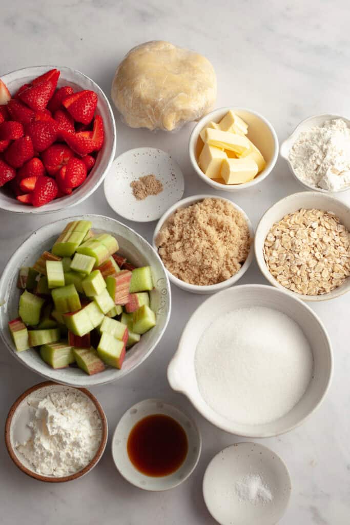 Ingredients needed to make strawberry rhubarb crumble pie, weighed out into small bowls.