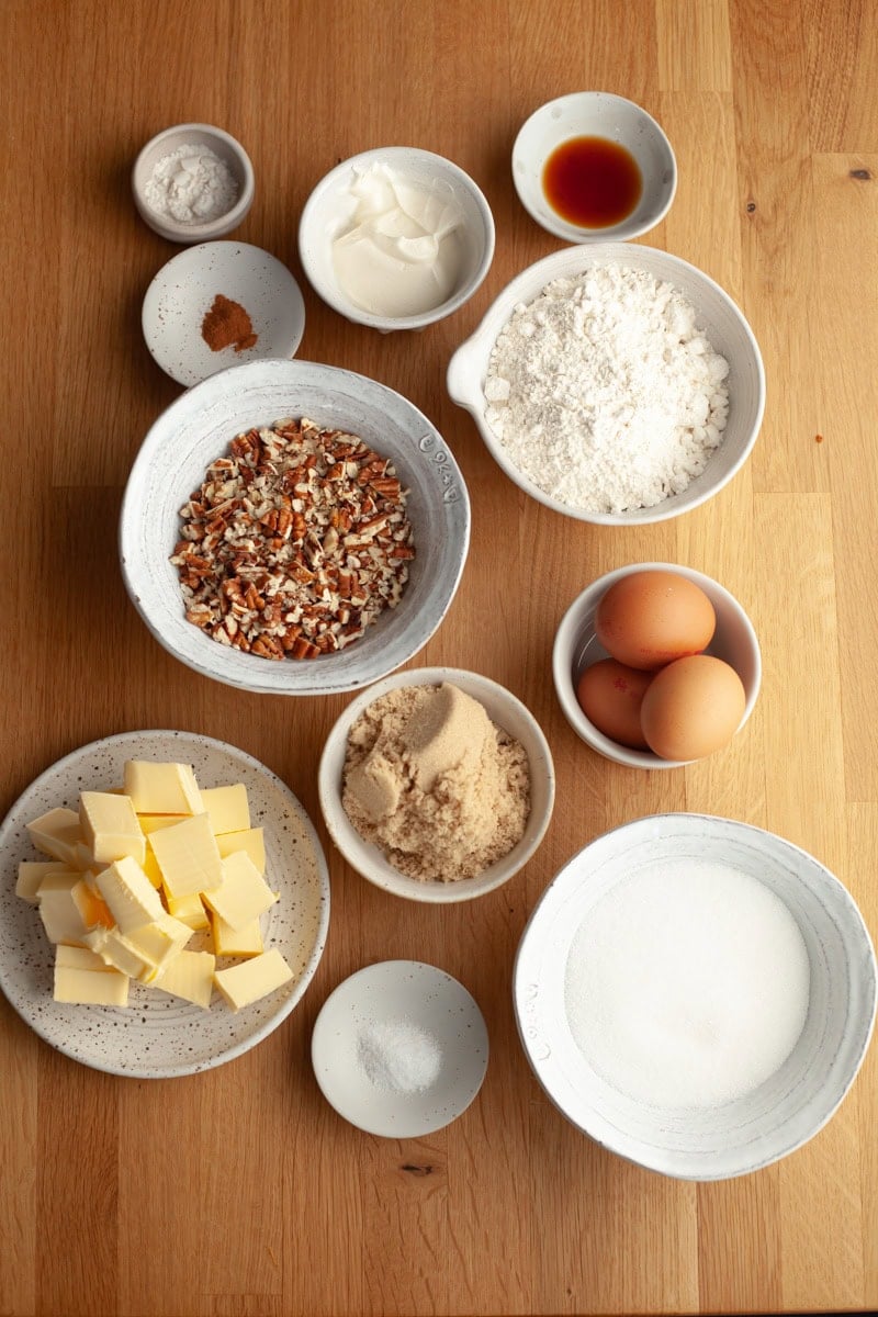 Ingredients needed to make butter pecan pound cake, weighed out into small bowls.