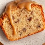 A slice of pecan pound cake with a caramel glaze on a small plate. Text reads "easy butter pecan pound cake".