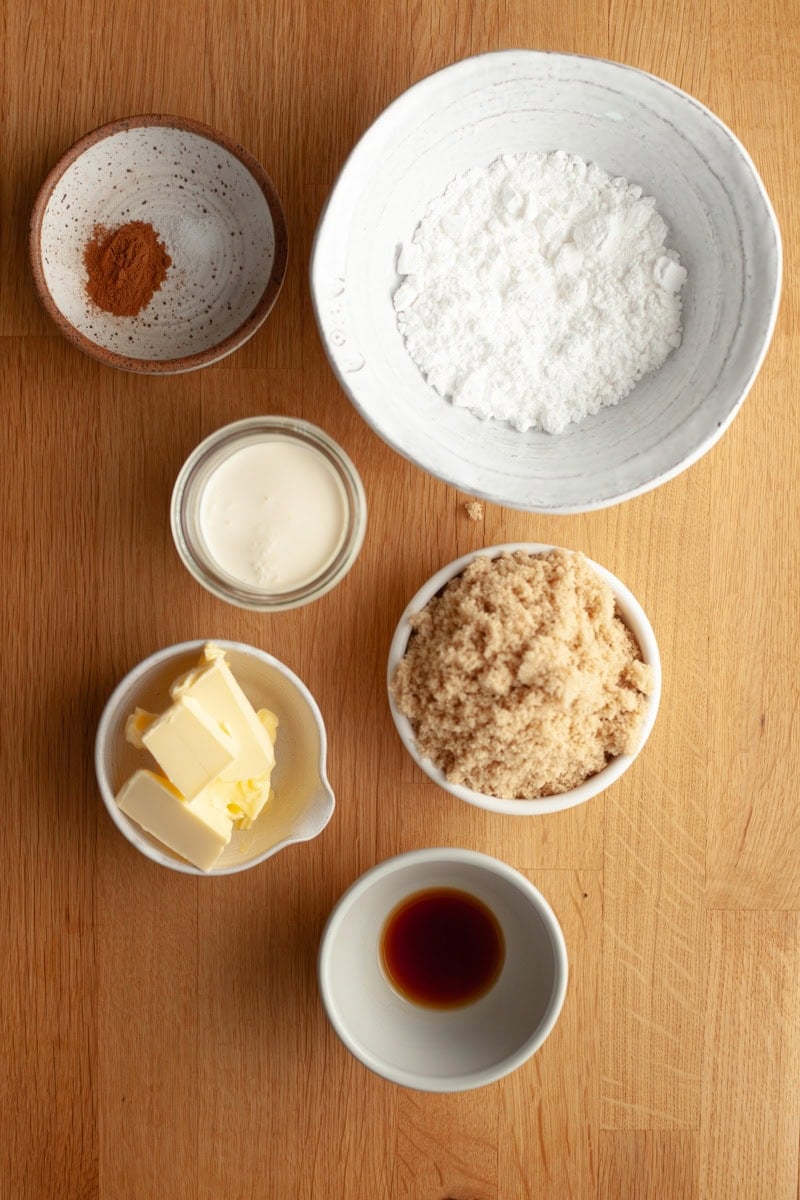 The ingredients needed to make a brown sugar cinnamon glaze, weighed out into small bowls.