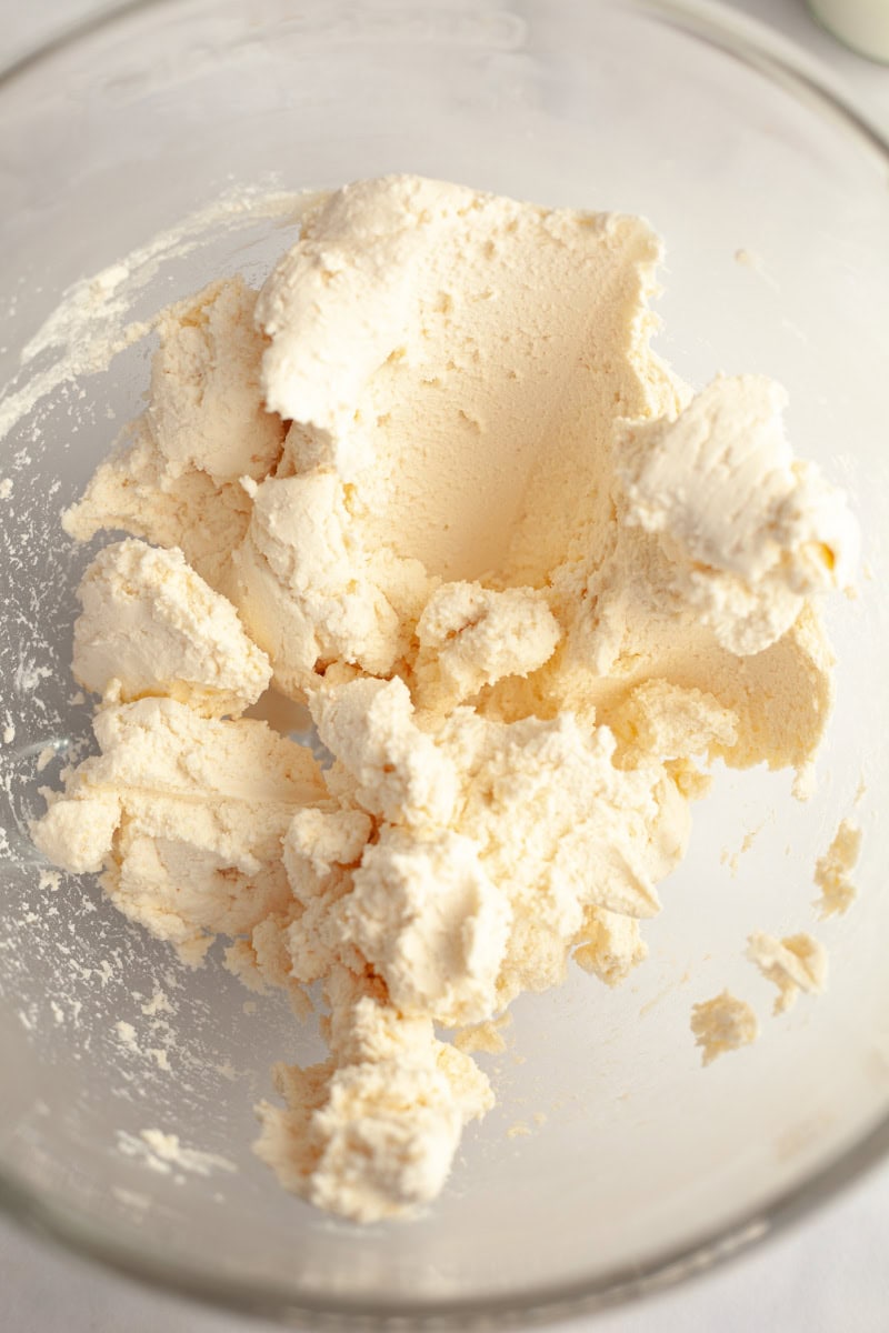 Brown butter frosting in a glass mixing bowl.