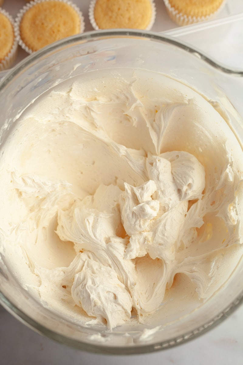 Brown butter frosting in a glass mixing bowl.