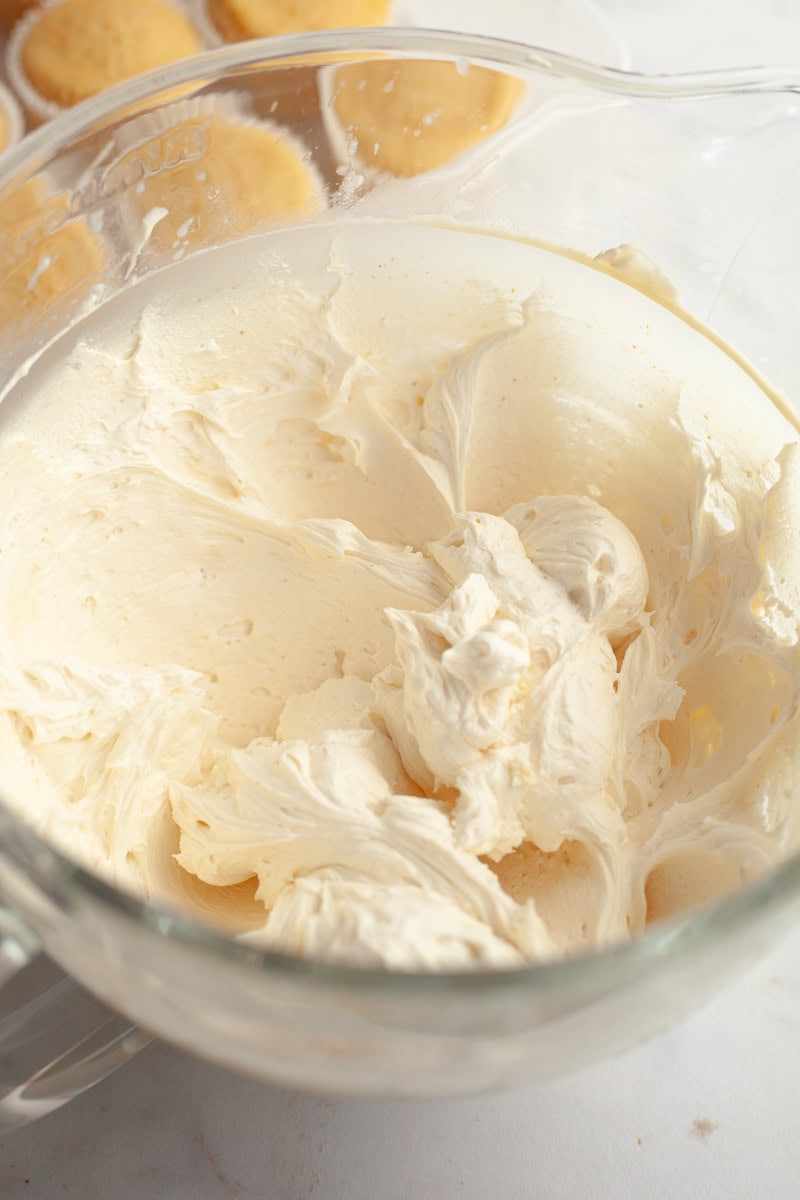 Brown butter frosting in a glass mixing bowl.