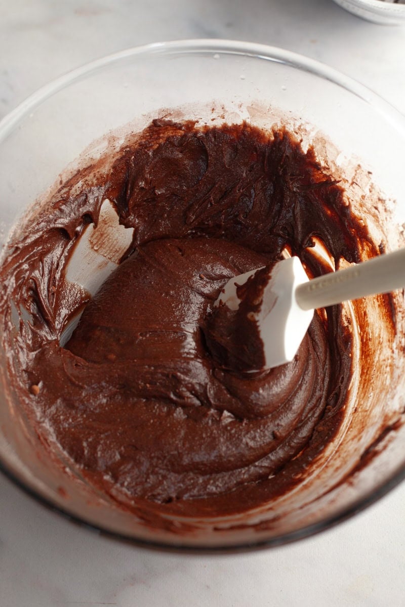 Chocolate cookie dough in a glass bowl.